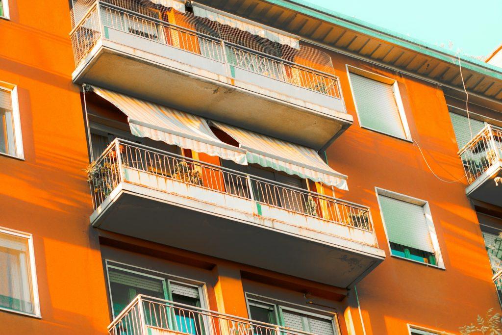 an orange building with balconies and balconies on the balconies